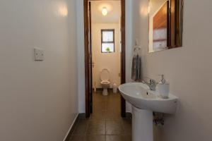 a bathroom with a sink and a toilet at Edmor Residences Riverside in Nairobi +43 photos