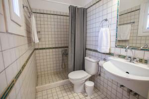 a bathroom with a toilet and a sink at Antiparos Vibes in Agios Georgios