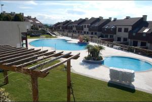 a large swimming pool with a row of buildings at COMPEJO RAEIROS O GROVE, S Vicente do Mar in O Grove