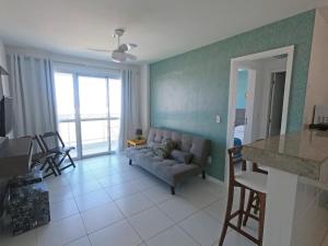 un salon avec un canapé et une table dans l'établissement PRAIA DO FORTE - PÉ NA AREIA - 6 hóspedes, à Cabo Frio