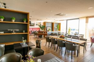 a dining room with tables and chairs in a restaurant at Hotel Campo in Renningen