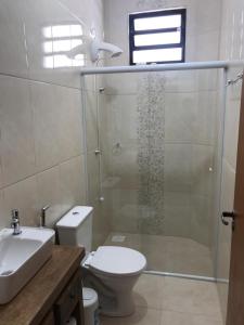 een badkamer met een douche, een toilet en een wastafel bij Casa - Próximo a UFSC e CENTRO - 5 KM in Florianópolis