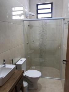 a bathroom with a shower and a toilet and a sink at Casa - Próximo a UFSC e CENTRO - 5 KM in Florianópolis +8 photos