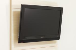 a flat screen tv sitting on a shelf at Hotel Municipal in Jabuticabal