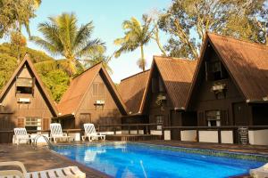 a resort with a swimming pool and a house at Chalés do Laurindo in Maciel