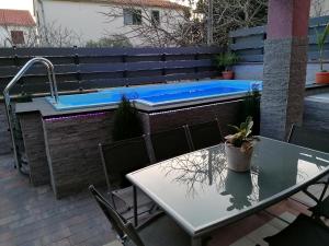 a patio with a table and a swimming pool at House Srima-Vodice Dalmatia in Srima