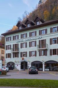 a hotel with a car parked in front of it at Hôtel National in Cluses