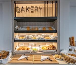 a display case filled with lots of different types of pastries at Alexandra Beach Resort & Spa in Tsilivi