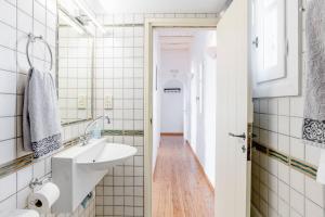 a bathroom with a sink and a mirror at Antiparos Vibes in Agios Georgios
