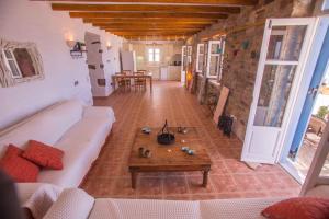 a living room with a couch and a coffee table at Antiparos Vibes in Agios Georgios