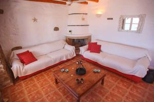 a living room with two white couches and a table at Antiparos Vibes in Agios Georgios