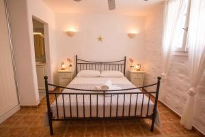 a bedroom with a bed with two night stands at Antiparos Vibes in Agios Georgios