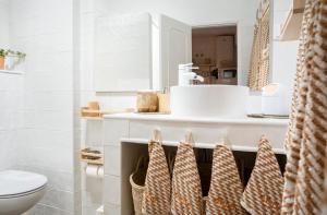 a bathroom with a toilet and a sink at Baixa de Faro Rooftop in Faro +44 photos