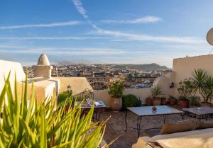 a balcony with a view of a city at Le Cèdre D'argent in Fès