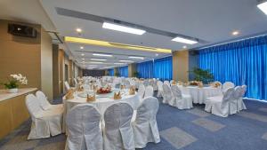 a banquet hall with white tables and white chairs at Holiday Inn Express Panjin Downtown, an IHG Hotel in Panjin