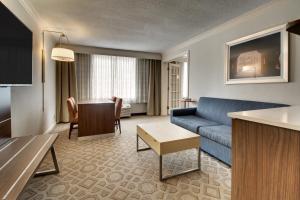 a living room with a couch and a table at Holiday Inn Express Poughkeepsie, an IHG Hotel in Poughkeepsie