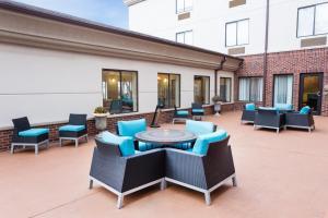 a patio with chairs and a table and chairs at Holiday Inn Express Princeton/I-77, an IHG Hotel in Princeton