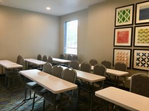 a classroom with tables and chairs and paintings on the wall at Holiday Inn Express - Grand Island by IHG in Niagara Falls