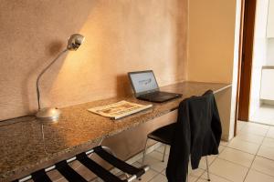a laptop computer sitting on top of a counter at Pampulha Flat in Belo Horizonte