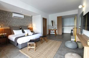 a hotel room with a bed and a television at Cosmopolis Multi-Venue in Larnaca
