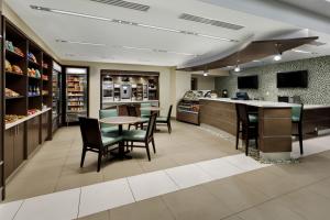 a restaurant with a table and chairs and a counter at Holiday Inn San Antonio-Riverwalk, an IHG Hotel in San Antonio