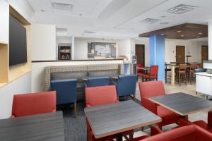 a restaurant with tables and chairs and a counter at Holiday Inn Express San Antonio North Riverwalk Area, an IHG Hotel in San Antonio