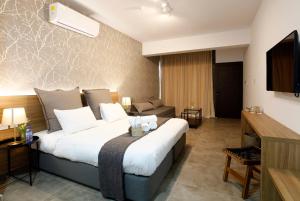 a hotel room with a bed and a couch at Cosmopolis Multi-Venue in Larnaca