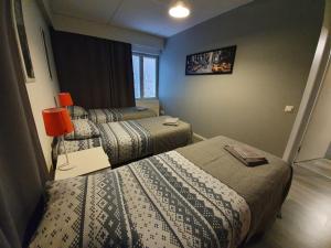 a hotel room with two beds in a room at Hamina Orange Apartments Ilves in Hamina