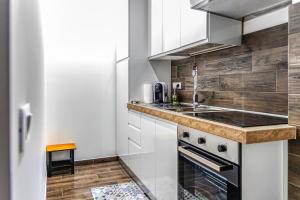a kitchen with a sink and a stove at Tribunale Basement Apartment in Messina +54 photos