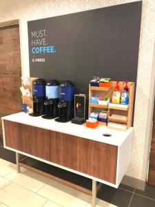 a coffee shop with a counter with some coffeefacts at Holiday Inn Express Richmond - Midtown, an IHG Hotel in Richmond