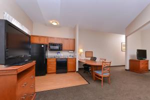 a room with a kitchen with a desk and a table at Candlewood Suites San Diego, an IHG Hotel in San Diego