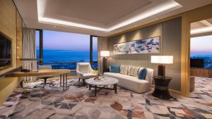 a living room with a couch and a table at Holiday Inn Suzhou Taihu Lake by IHG in Suzhou