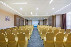 an empty conference room with yellow chairs and a window at Holiday Inn Express Baoji City Centre by IHG in Baoji