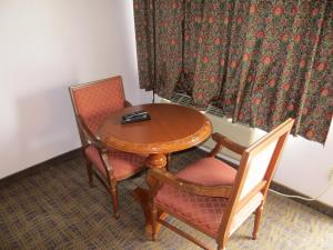 a wooden table and two chairs and a table and chairuggest at Park Cienega Motel in Los Angeles