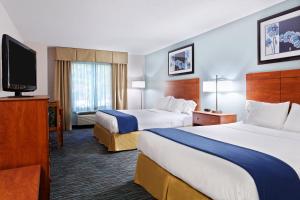 a hotel room with two beds and a flat screen tv at Holiday Inn Express Richmond-Brandermill-Hull Street by IHG in Brandermill