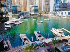 a group of boats docked in a harbor in a city at Damac Heights by Fendi casa in Dubai