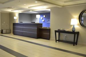 a waiting area of a hospital with a desk and a mirror at Holiday Inn Express Hotels Biddeford, an IHG Hotel in Biddeford