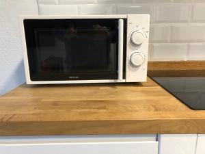 a microwave oven sitting on top of a counter at La Pineda in Pals