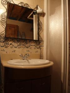a bathroom with a sink and a mirror at Apartamentos Rurales Casa del Tio Juan in Olocau del Rey