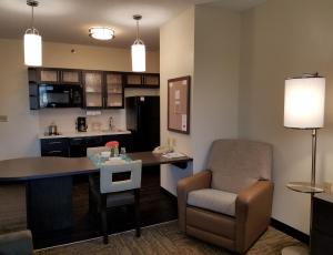 a kitchen with a desk and a chair in a room at Candlewood Suites - East Syracuse - Carrier Circle, an IHG Hotel in East Syracuse