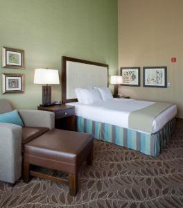 A bed or beds in a room at Holiday Inn Express & Suites Logan, an IHG Hotel