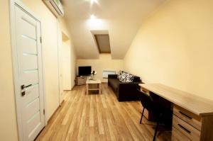 a living room with a couch and a table at Wonderful flat on city center (Mukachivska 4/16) in Uzhhorod