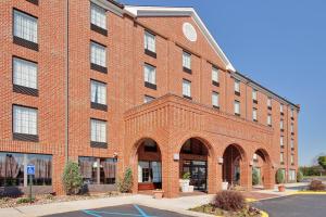 a large red brick building with arched windows at Holiday Inn Express Harrisburg East by IHG in Harrisburg