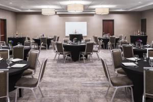 a conference room with tables and chairs and a whiteboard at Holiday Inn Odessa by IHG in Odessa +46 photos