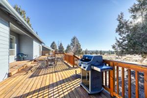a grill on the deck of a house at Eagle Crest Nature Retreat in Redmond