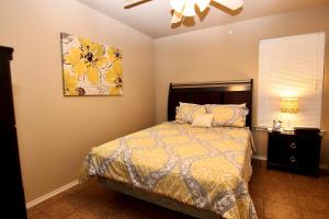 a bedroom with a bed and a painting on the wall at Shady River Oasis in New Braunfels +14 photos