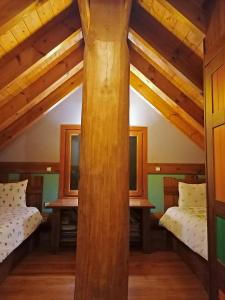 A bed or beds in a room at Mythica Chalet