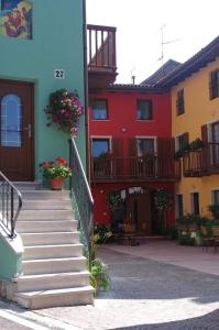 a group of buildings with stairs and flowers at B&B El Pojo in Ala