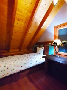 A bed or beds in a room at Mythica Chalet