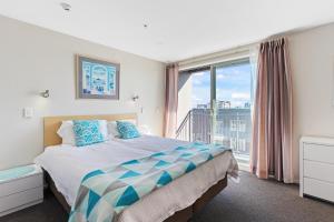 a bedroom with a bed and a large window at Apartment in the heart of the city in Christchurch